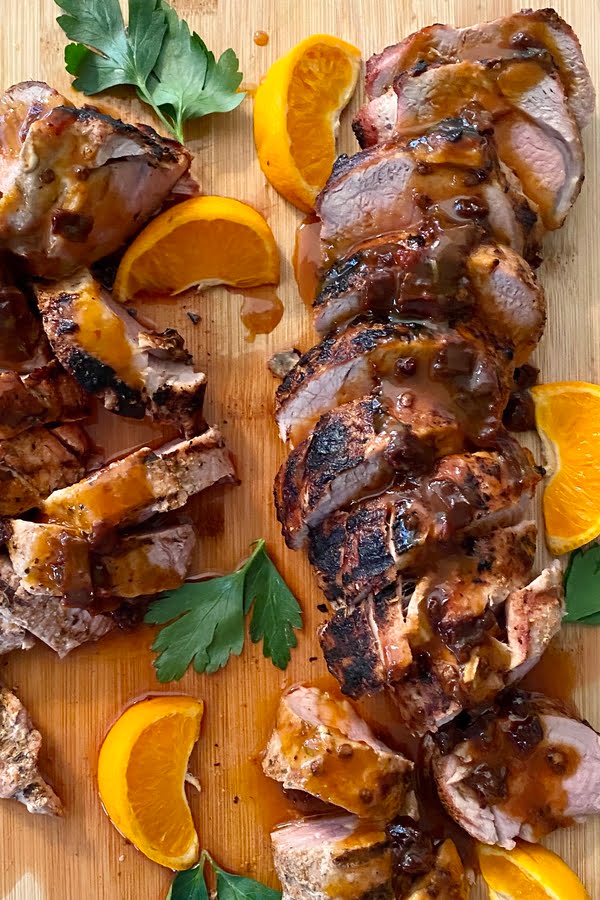grilled and sliced pork tenderloin with a chipotle honey and orange sauce 