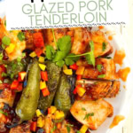 glazed pork tenderloin sliced and on a plate.