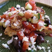 A plate of balsamic chicken with salsa.