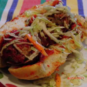 A hoagie sandwich with meatballs.