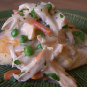 Creamy chicken a la king severed on a biscuit.
