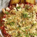 a baked shrimp with feta and tomatoes and crostinis