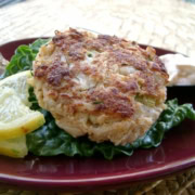 A jumbo lump crab cake with a lemon wedge.