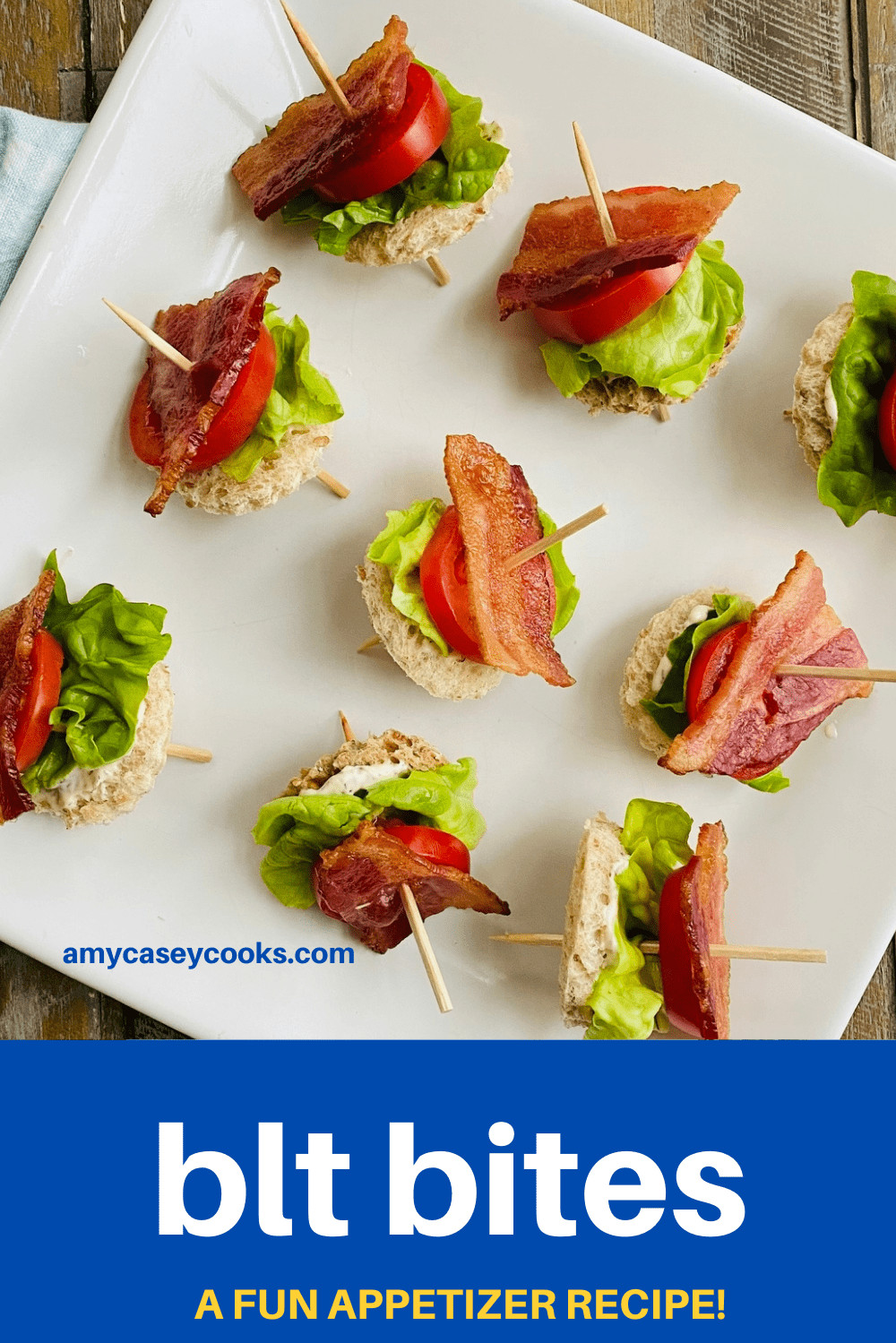 Bacon appetizers on toothpicks on a white platter.