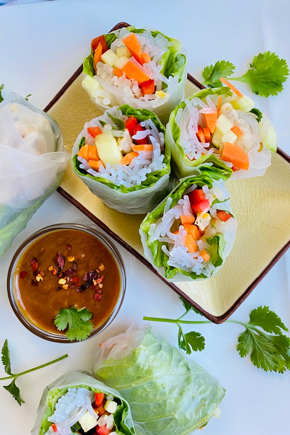 fresh spring rolls cut in half with peanut sesame dipping sauce