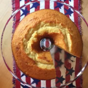 pound cake with a slice cut out on a glass stand