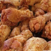 Fried chicken wings cooling on a wire rack.