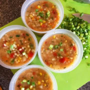 4 take out containers with vegetable barley soup.