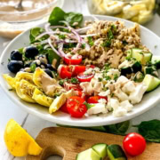 quinoa bowls with artichokes, olives, feta and tahini dressing