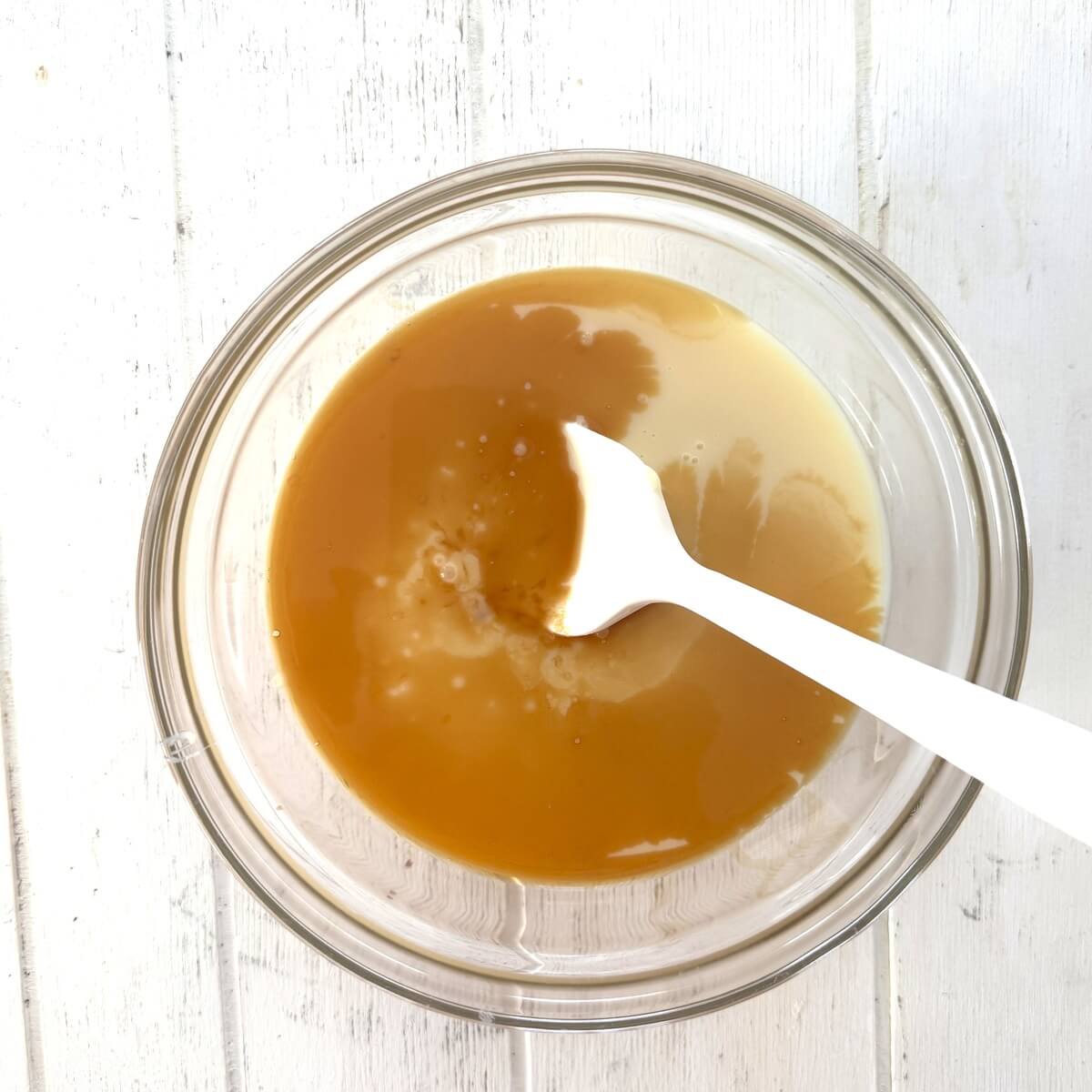 Sweetened condensed milk, vanilla and kosher salt in a bowl.