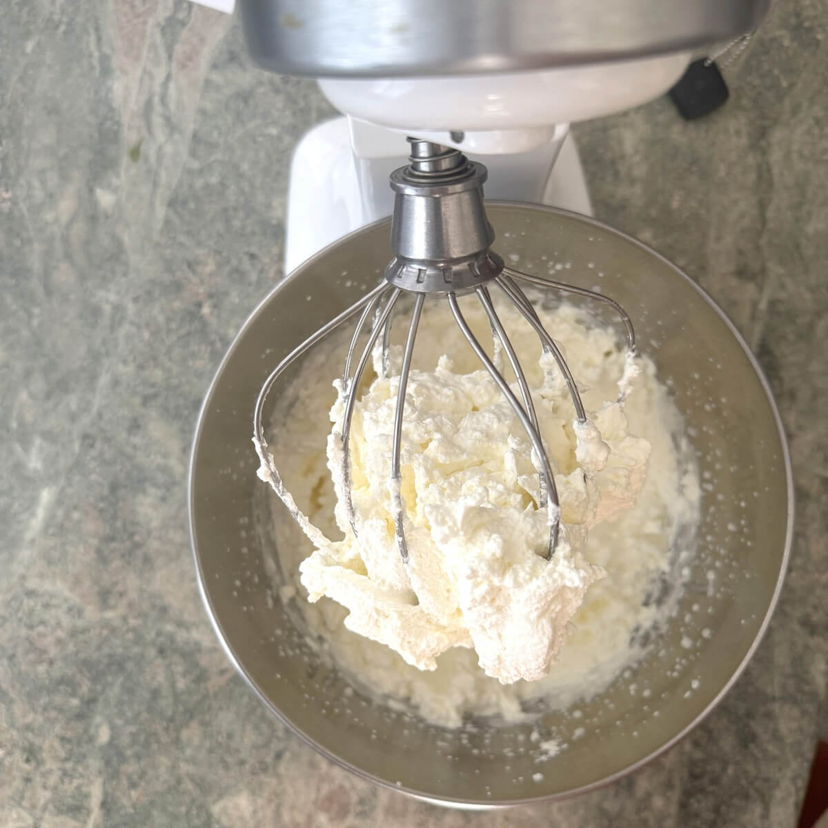 Homemade whipped cream on a beater.