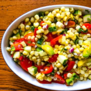 a side dish of summer produce with tomatoes and cucumbers
