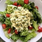 Deviled egg salad over lettuce and with cherry tomatoes.