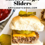 a mini cheeseburger slider with a pickle.