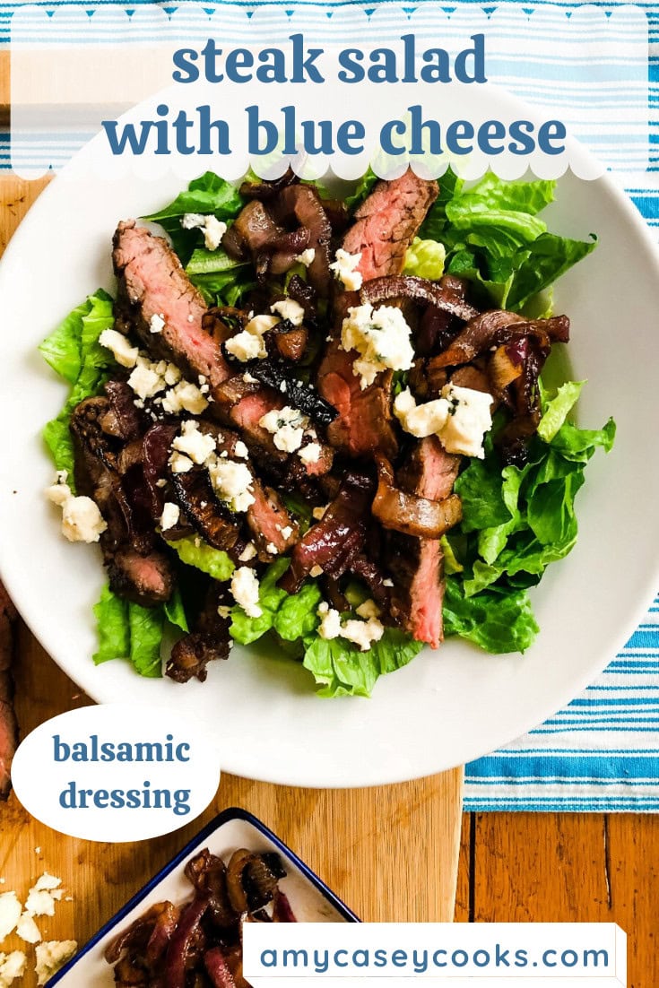 An entree salad with steak and blue cheese.