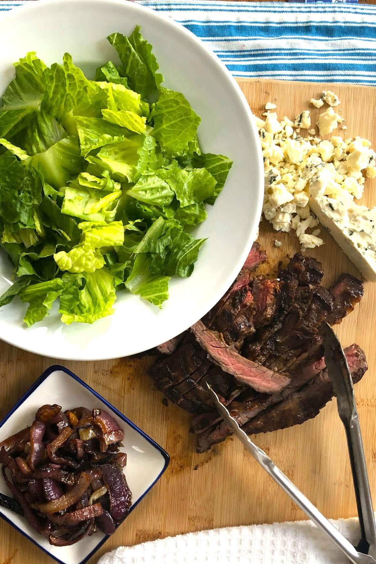Chopped romaine lettuce, crumbled blue cheese, roasted red onions, sliced skirt steak.