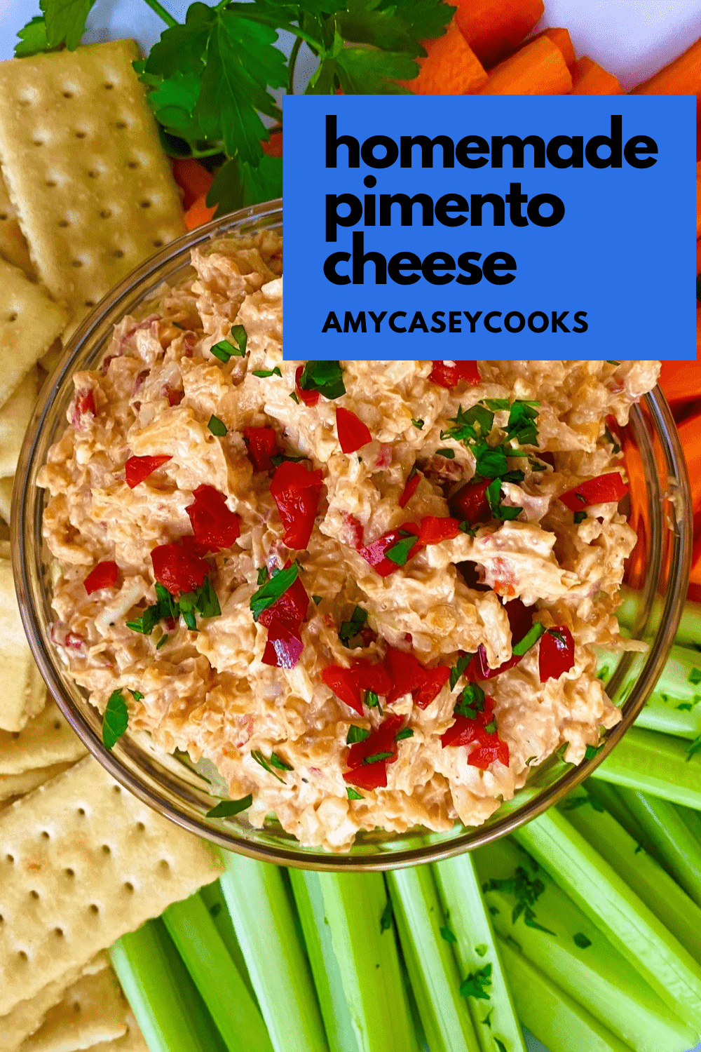 bowl of pimento cheese with celery, carrots and crackers