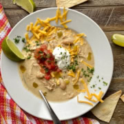 bowl of chicken enchilada soup with cheddar cheese