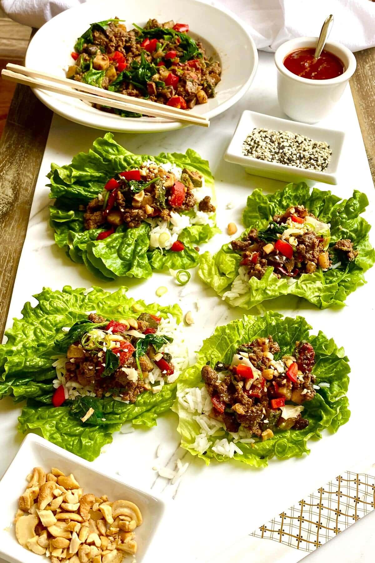 4 Korean beef lettuce wraps and sesame seeds.