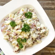 bowl of creamy potato salad with dill pickles