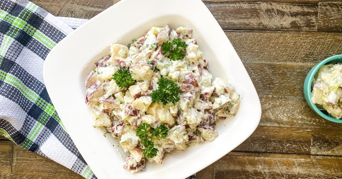 bowl of creamy potato salad with dill pickles