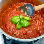 pot of marinara with fresh basil