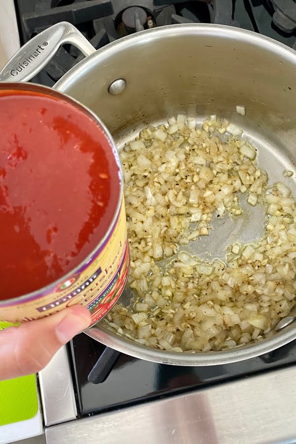 sauteing onions and a can of crushed tomatoes