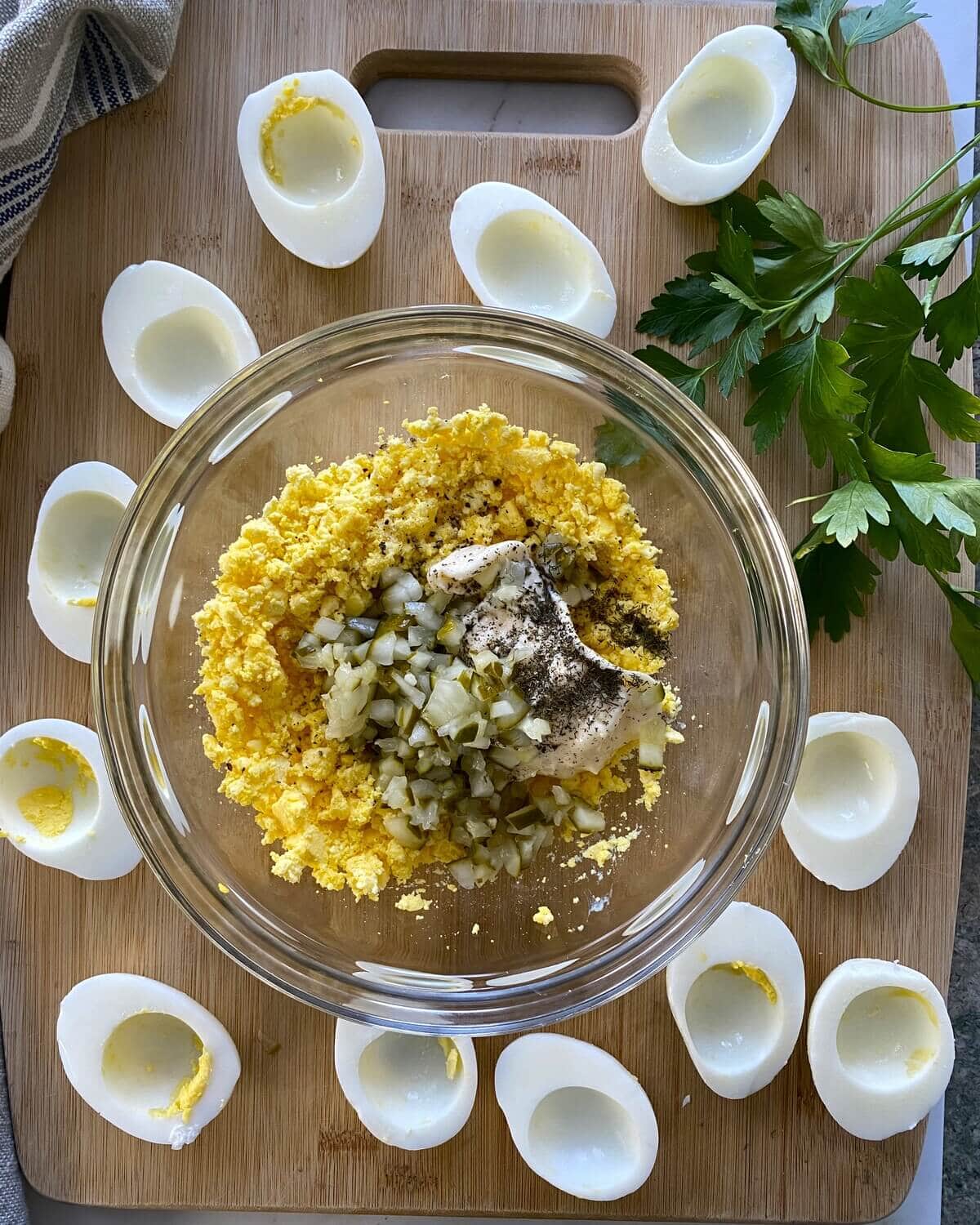 Ingredients for deviled eggs in a glass bowl.