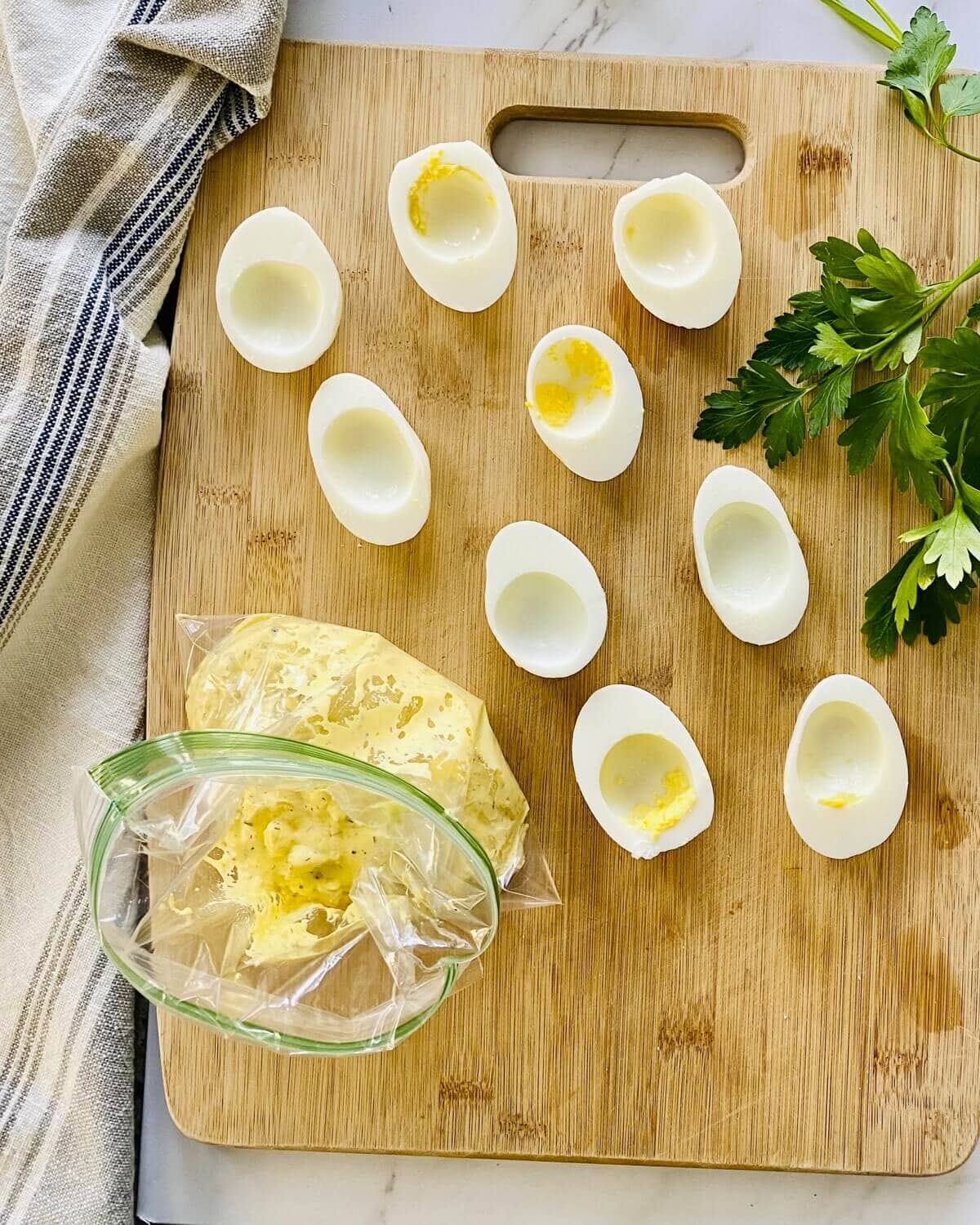 Empty egg white halves and filling for deviled eggs.