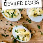 Stuffed eggs on a cutting board.