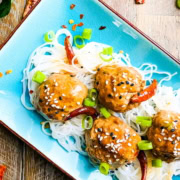 spicy meatballs with red chili peppers over rice noodles
