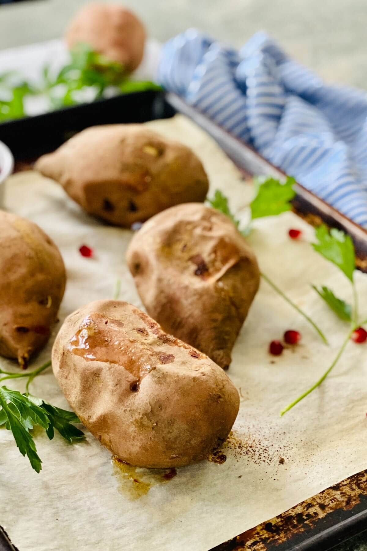 Baked sweet potatoes on a baking sheet.