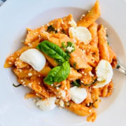bowl of pasta with a creamy tomato sauce and fresh mozzarella