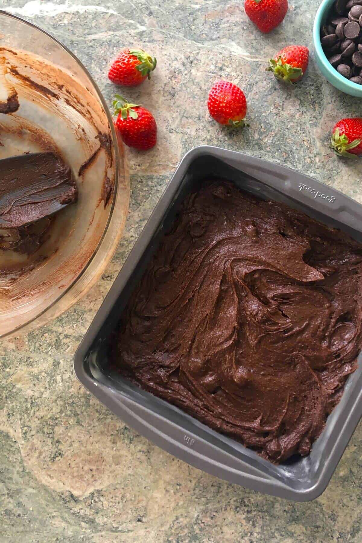 brownie batter in a metal baking pan.