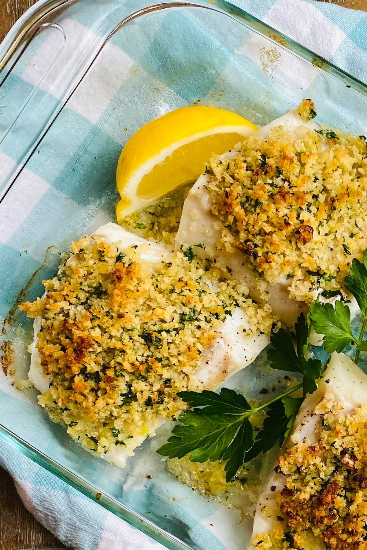 a glass dish with baked cod with garlic panko