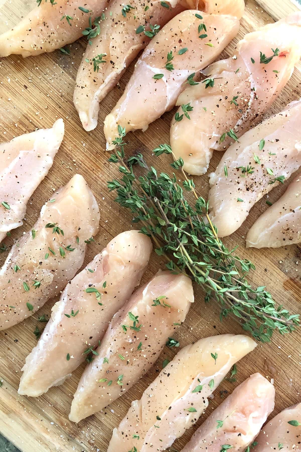 chicken tenderloins seasoned with salt, pepper and fresh thyme for balsamic chicken