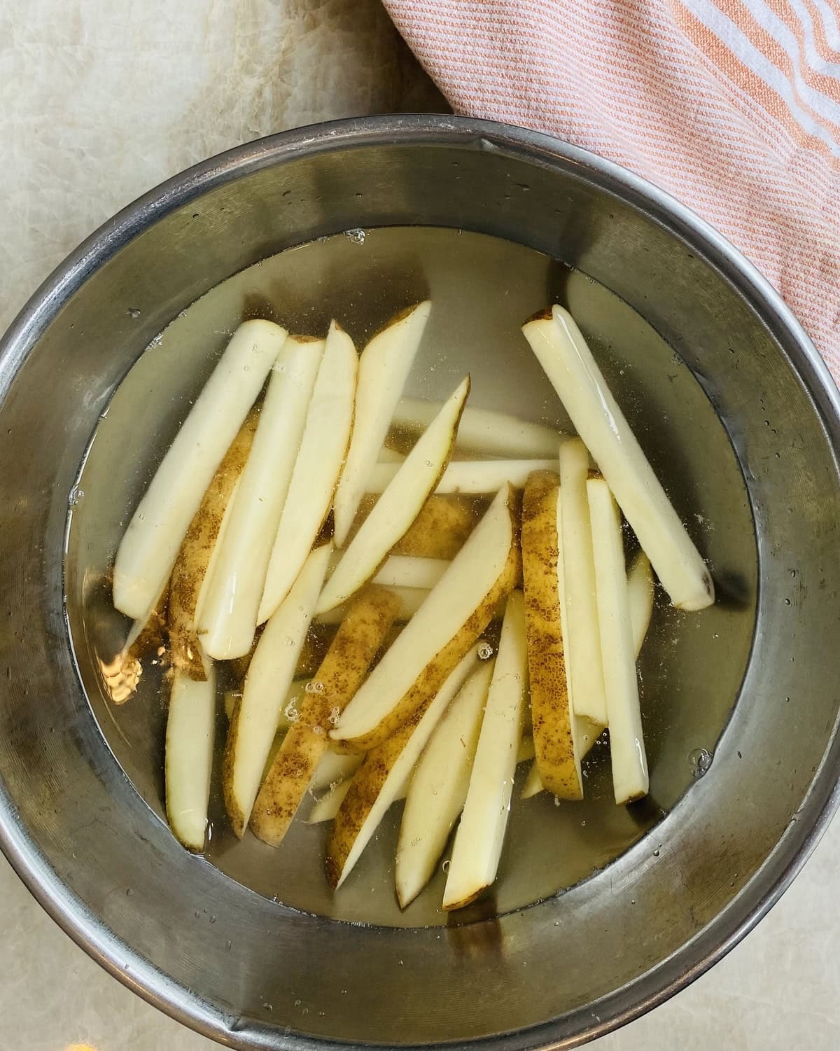Cut potatoes soaking in cold water.