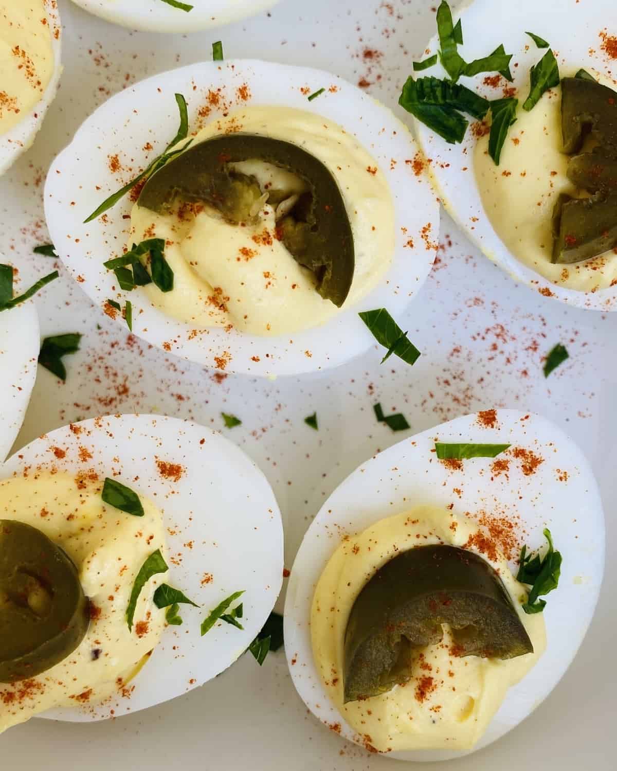 deviled eggs with slices of pickled jalapenos