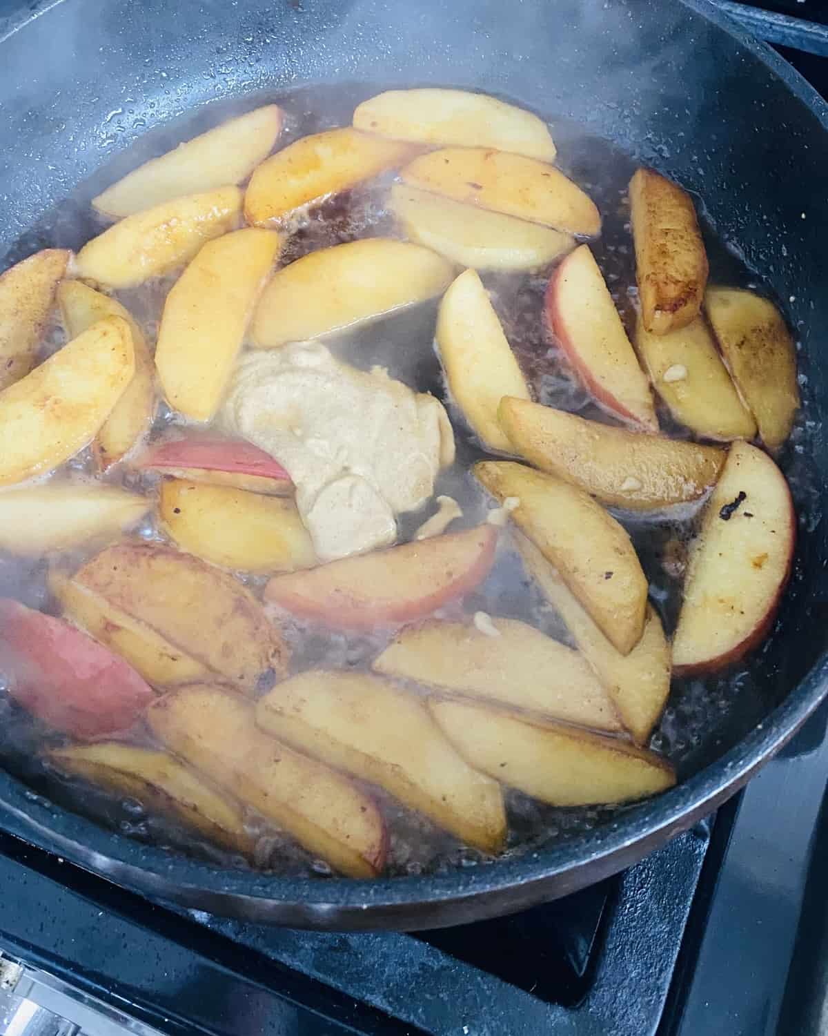 Sauteing apples in butter with maple syrup and Dijon mustard.