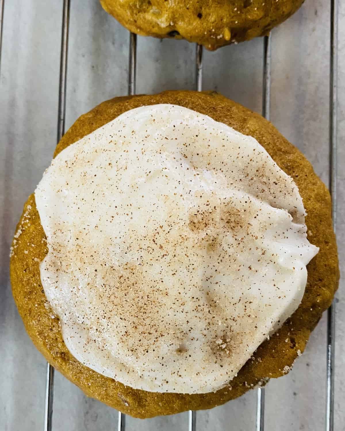single pumpkin spice cookie with buttercream frosting