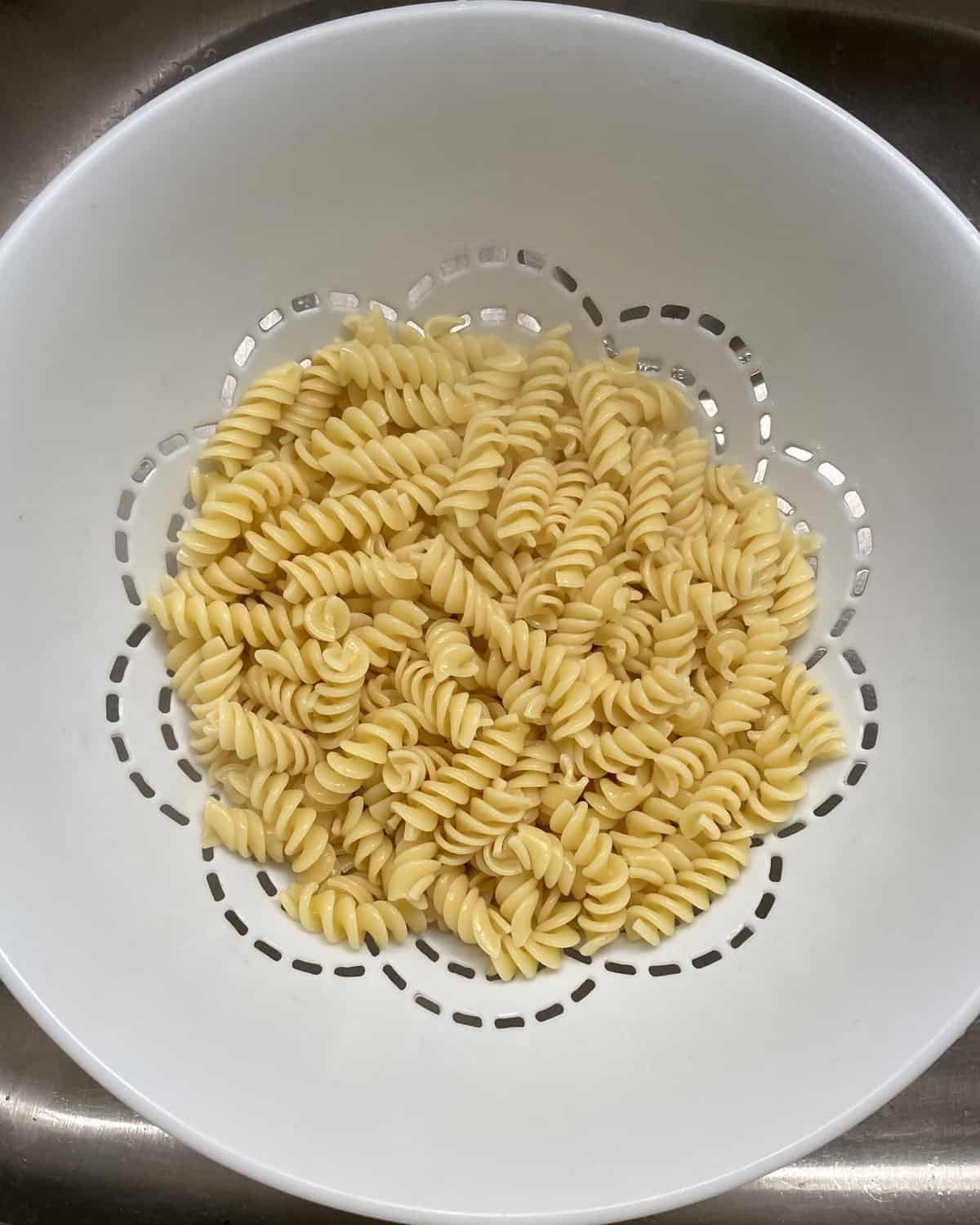 draining cooked pasta