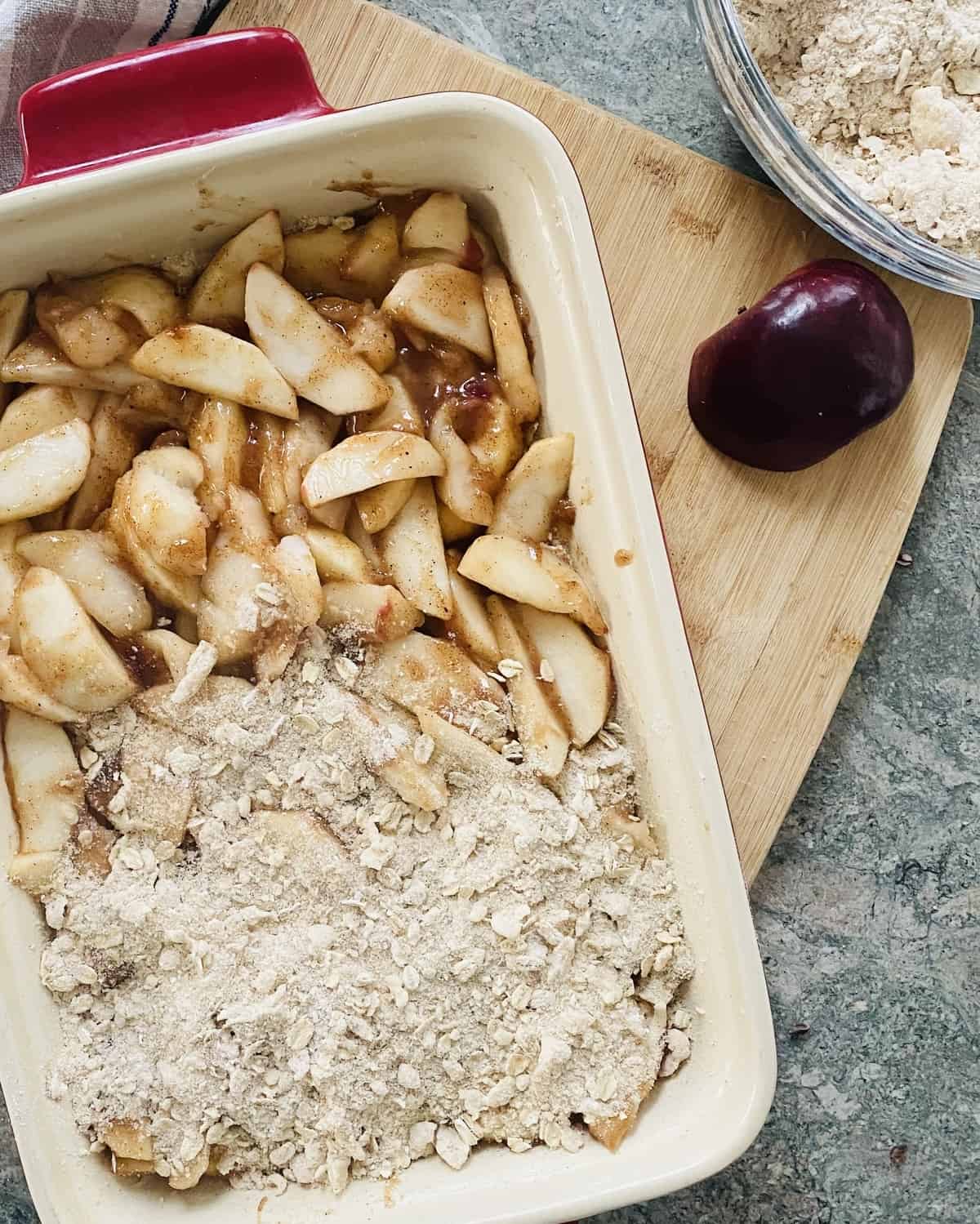 Baking dish with unbaked apple oat bars.