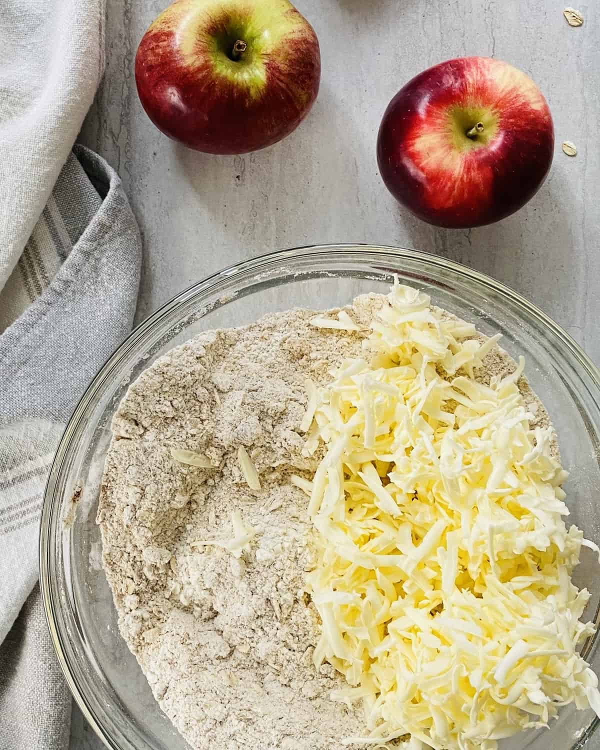 Flour and sugar with shredded butter in a bowl.