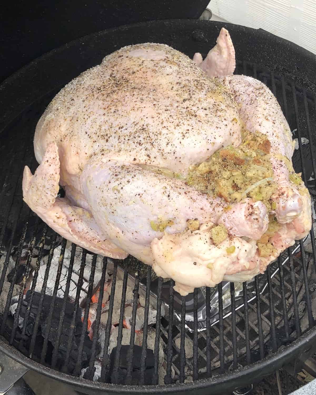 turkey with stuffing on a hot charcoal grill