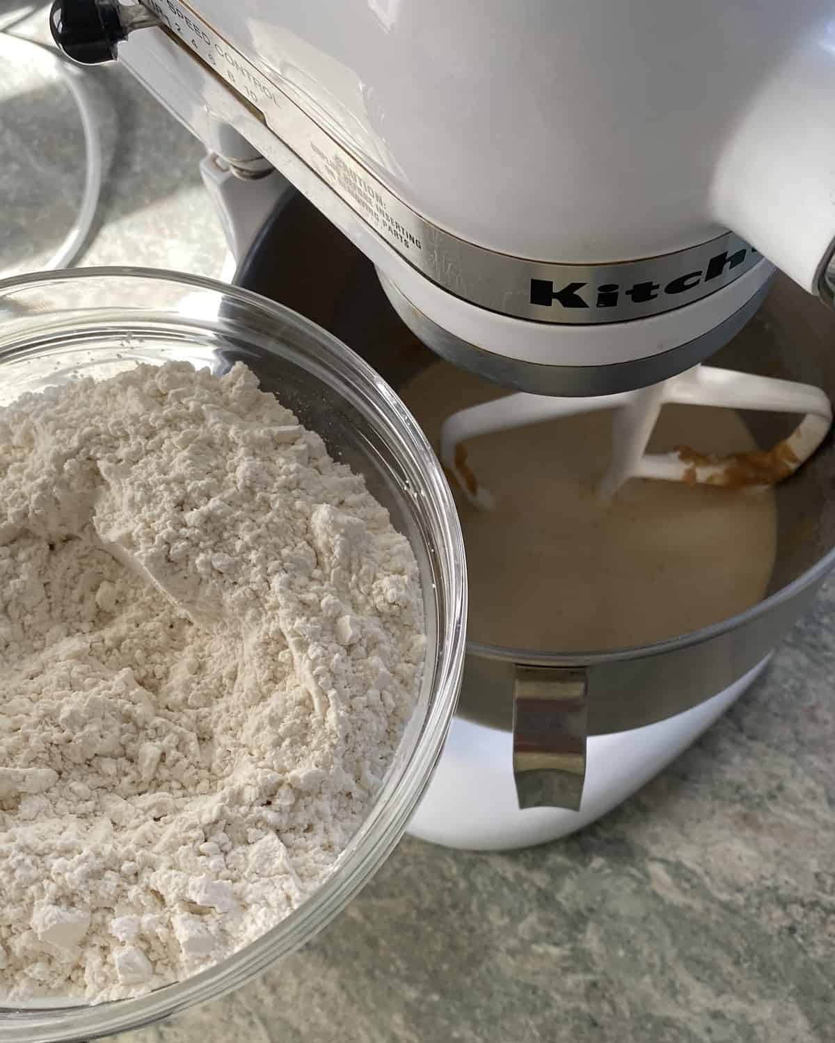 adding flour to peanut butter bread batter