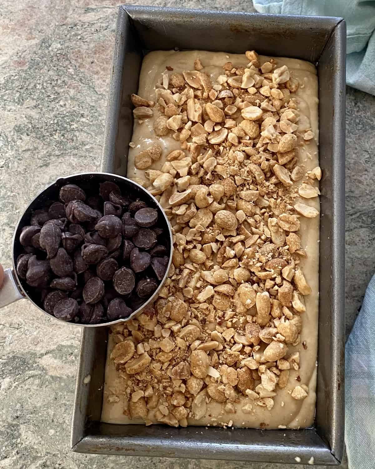 adding chocolate chips to peanut butter bread batter