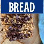 Slices of peanut butter bread topped with chocolate chips and peanuts.