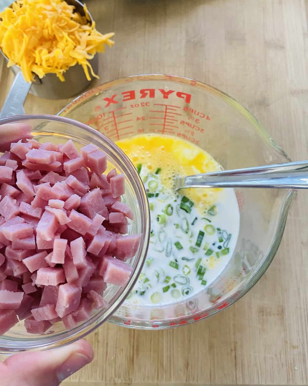 A bowl of chopped ham and quiche filling.