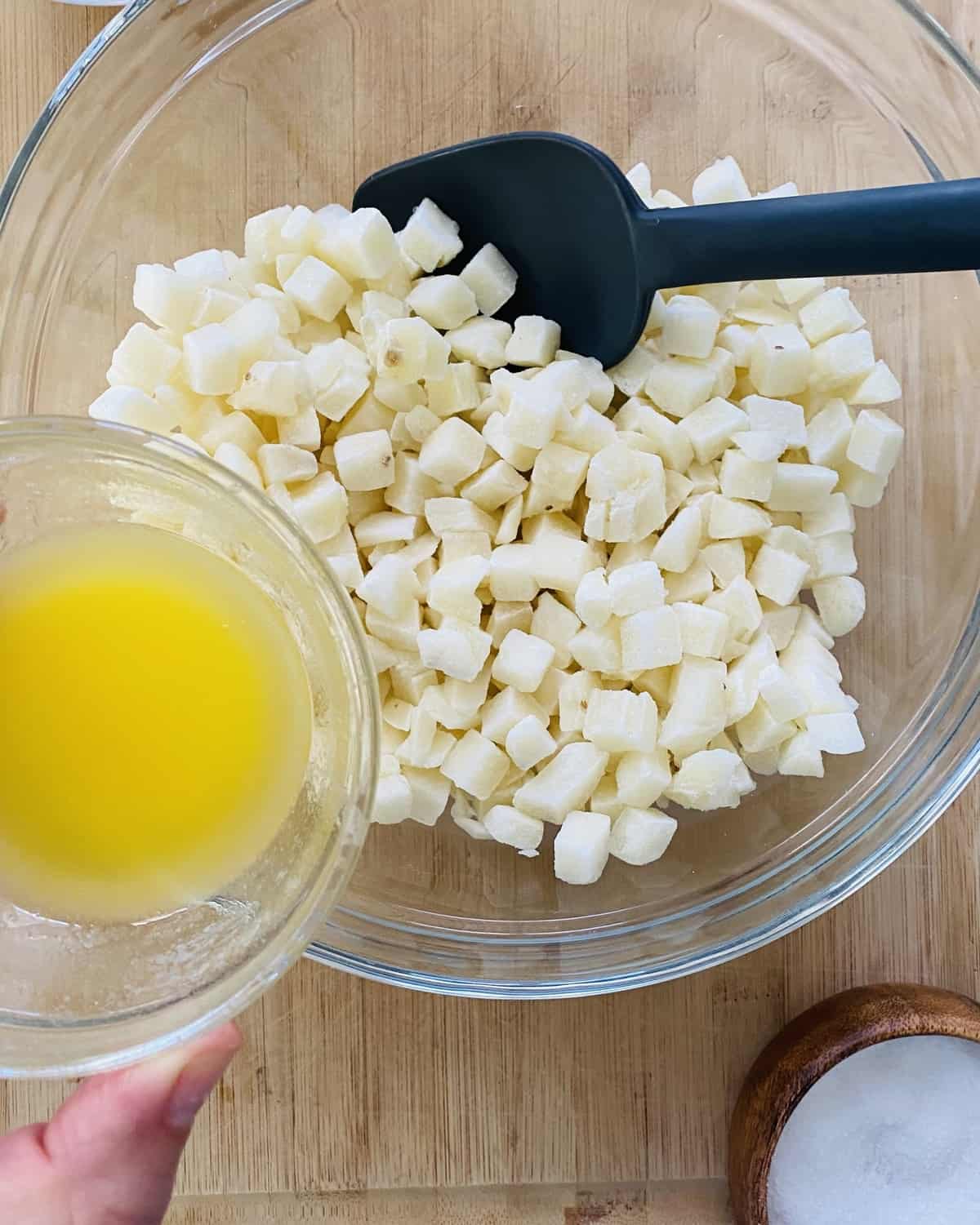 A bowl of hash browns and melted butter.
