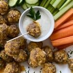 sausage meatballs on a platter with veggies and dip